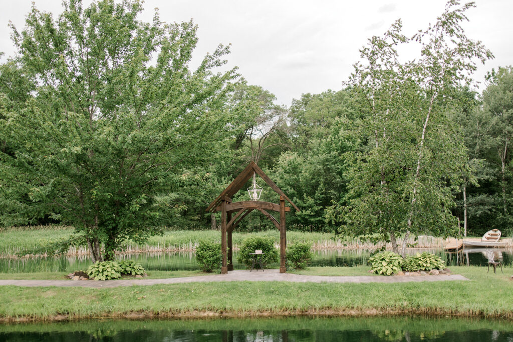 Waterfront pond ceremony at wedding venue in Eau Claire, WI