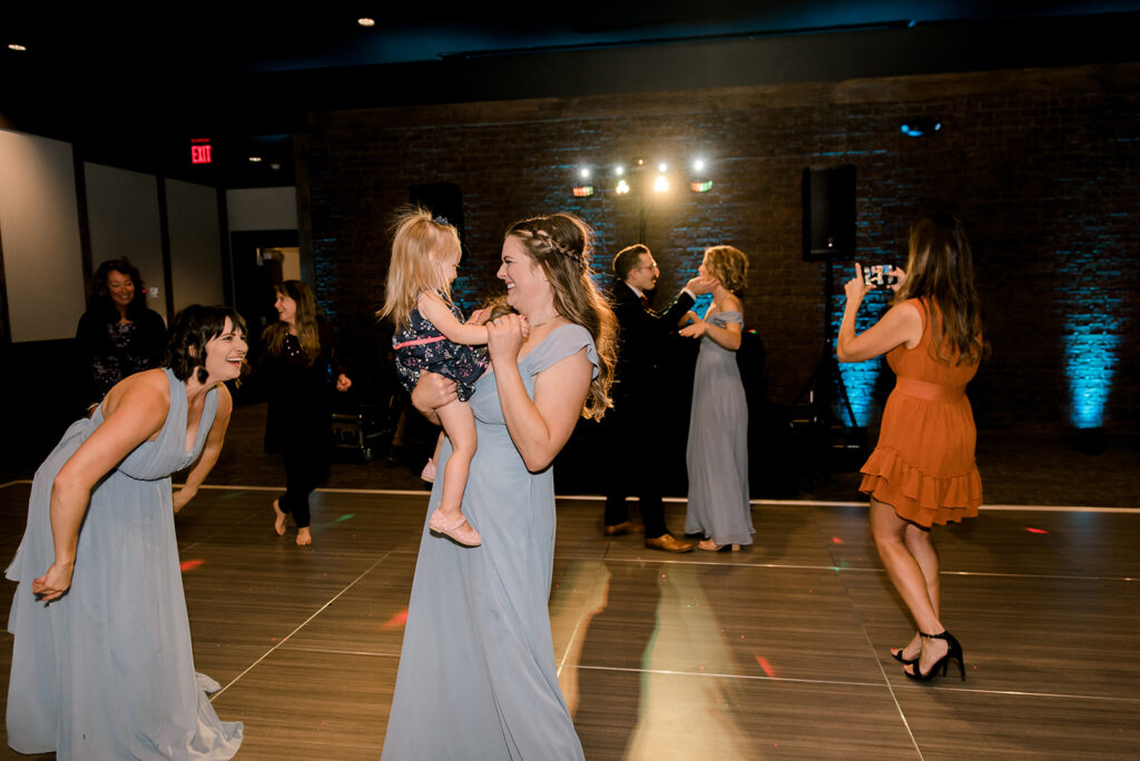 Bridesmaids dancing at Tattersall Distilling during wedding reception