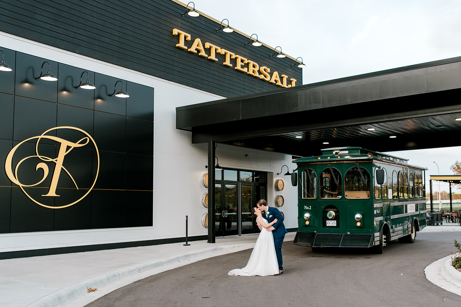 A couple kisses in front of Tattersall Distillery wedding venue