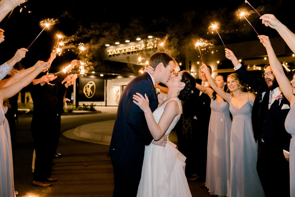 Bride and groom kiss during sparkler exit at Tattersall Distilling Wedding 