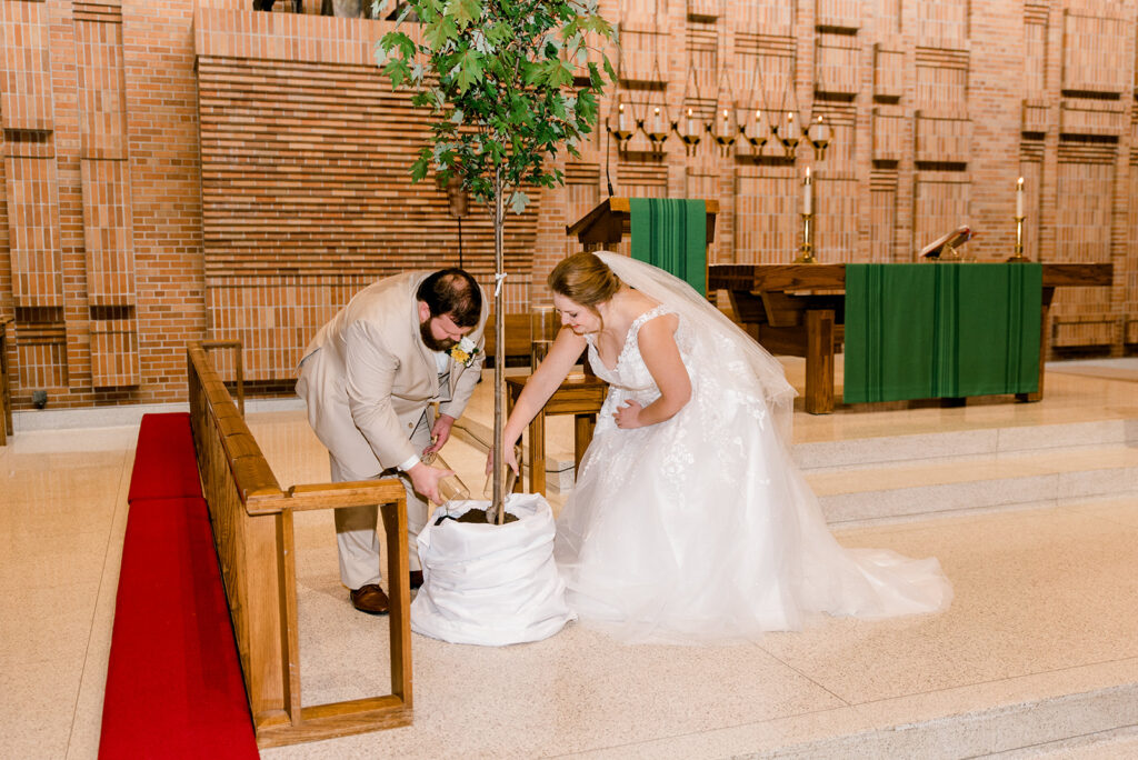 Bride and groom pouring soil together in their wedding unity ceremony
