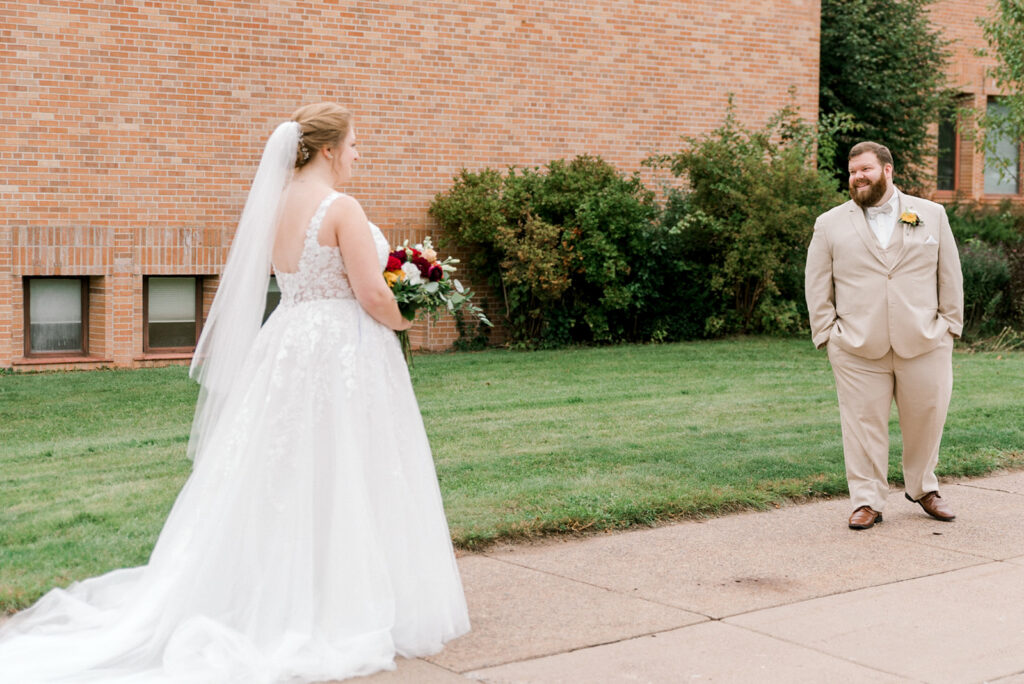 Groom turns to see his bride during their wedding day first look