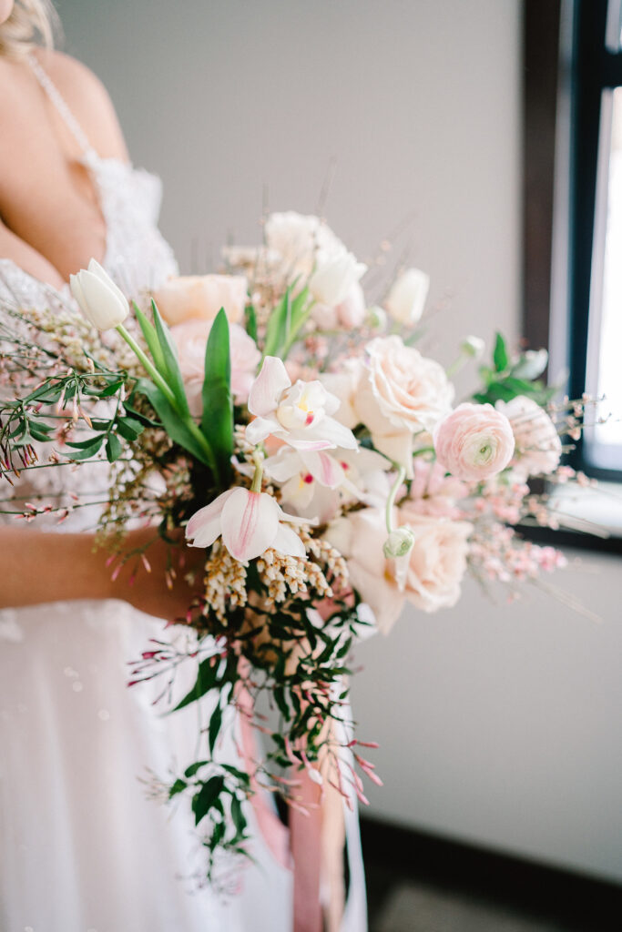 A bride hold a pink and green wedding bouquet.  Perfect for a spring wedding in Wisconsin.