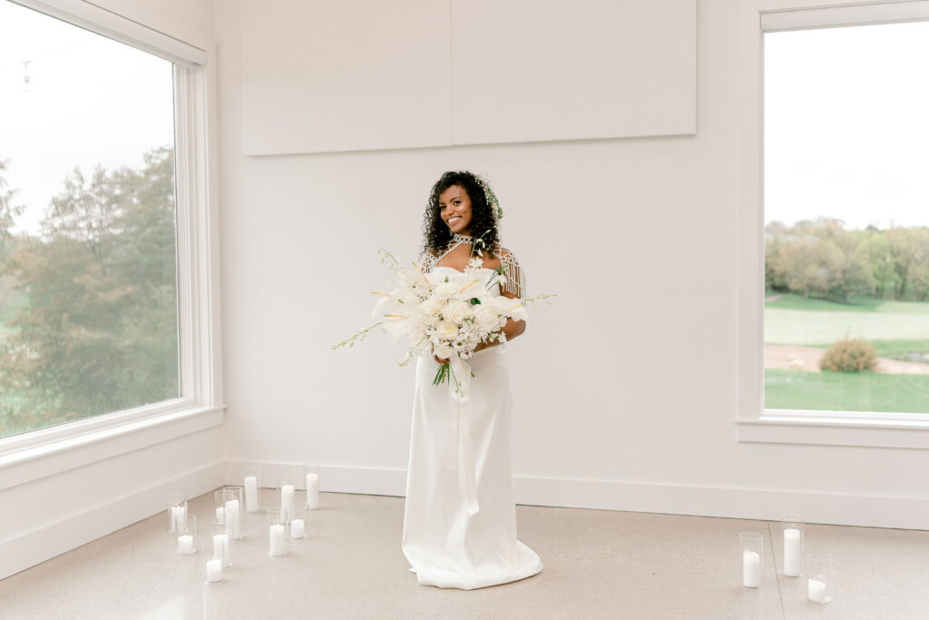 A bride holds her bouquet in the reception area at The Aisling